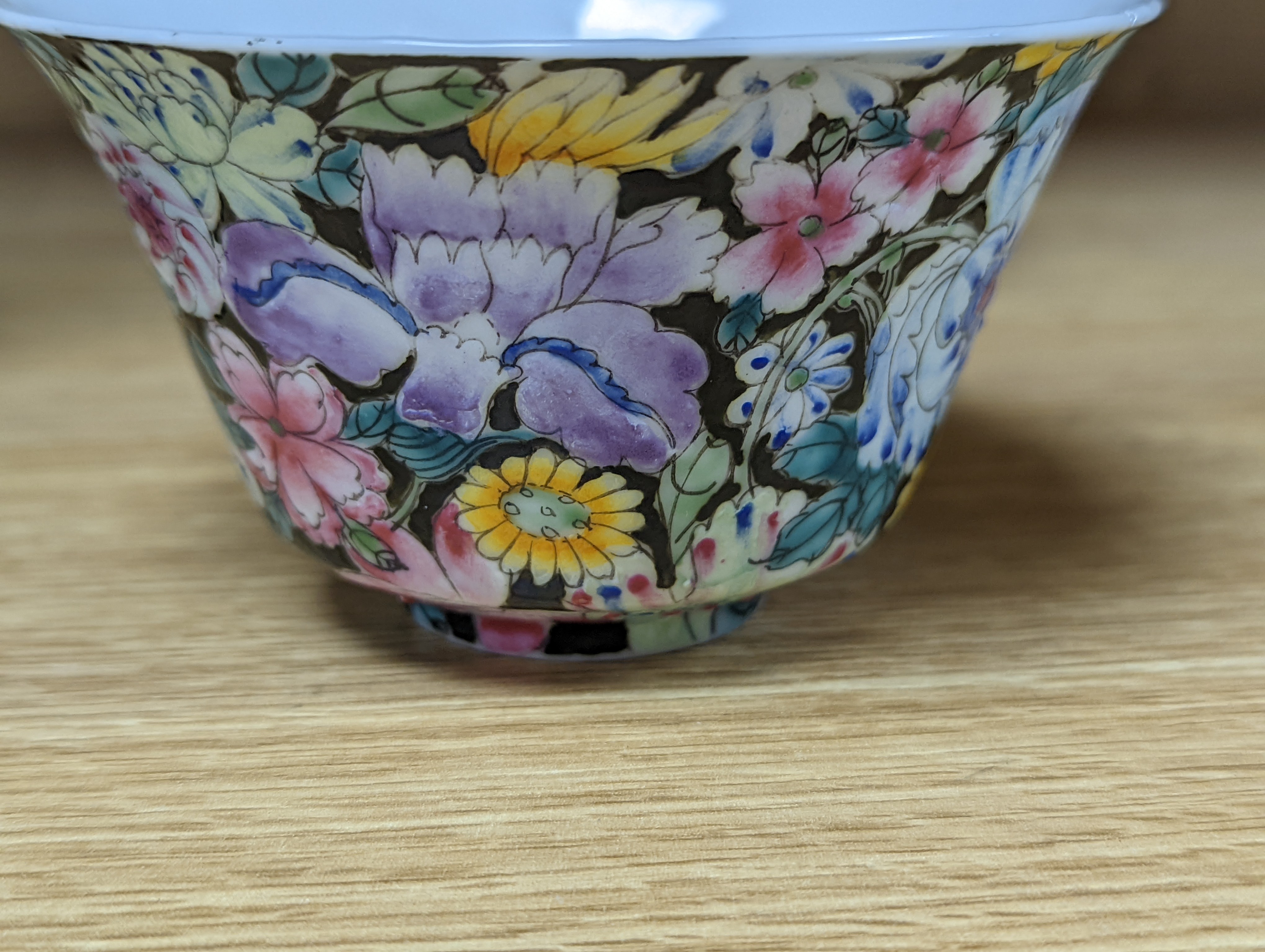 A pair of Chinese enamelled porcelain rice bowls, covers and stands and an odd bowl